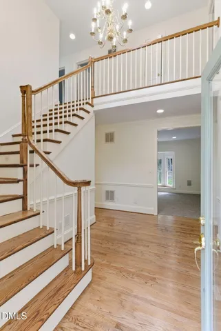 a view of entryway and hall with wooden floor