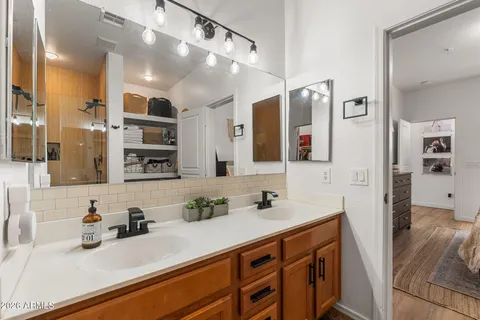 a bathroom with a sink double vanity and a shower
