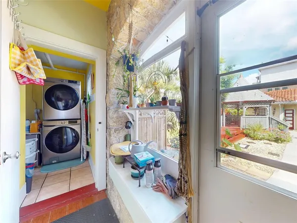 a living room with furniture a rug and a window