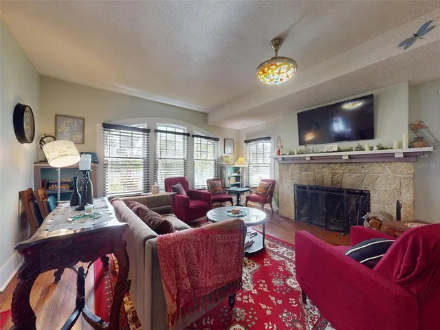 a bedroom with furniture and a large window