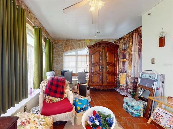 a view of staircase with lots of frames on wall and a large window