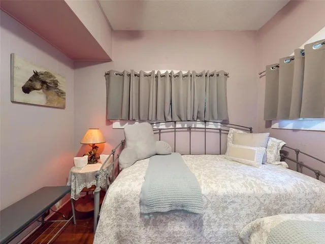 a bedroom with furniture and a flat screen tv