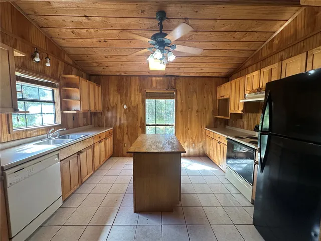 a kitchen with stainless steel appliances granite countertop a refrigerator and a stove
