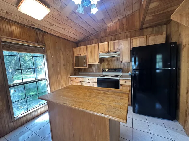 a kitchen with cabinets and window