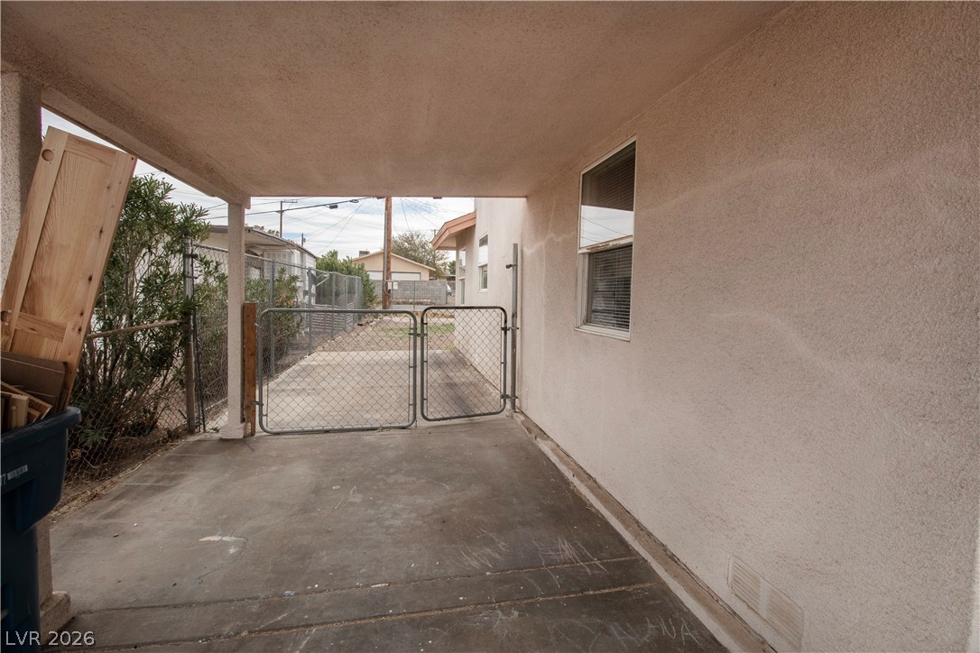 119 West Victory Road Henderson, NV 89015 - Photo 24 of 26 A side pathway leads to a fenced-in yard, offering practical outdoor space.