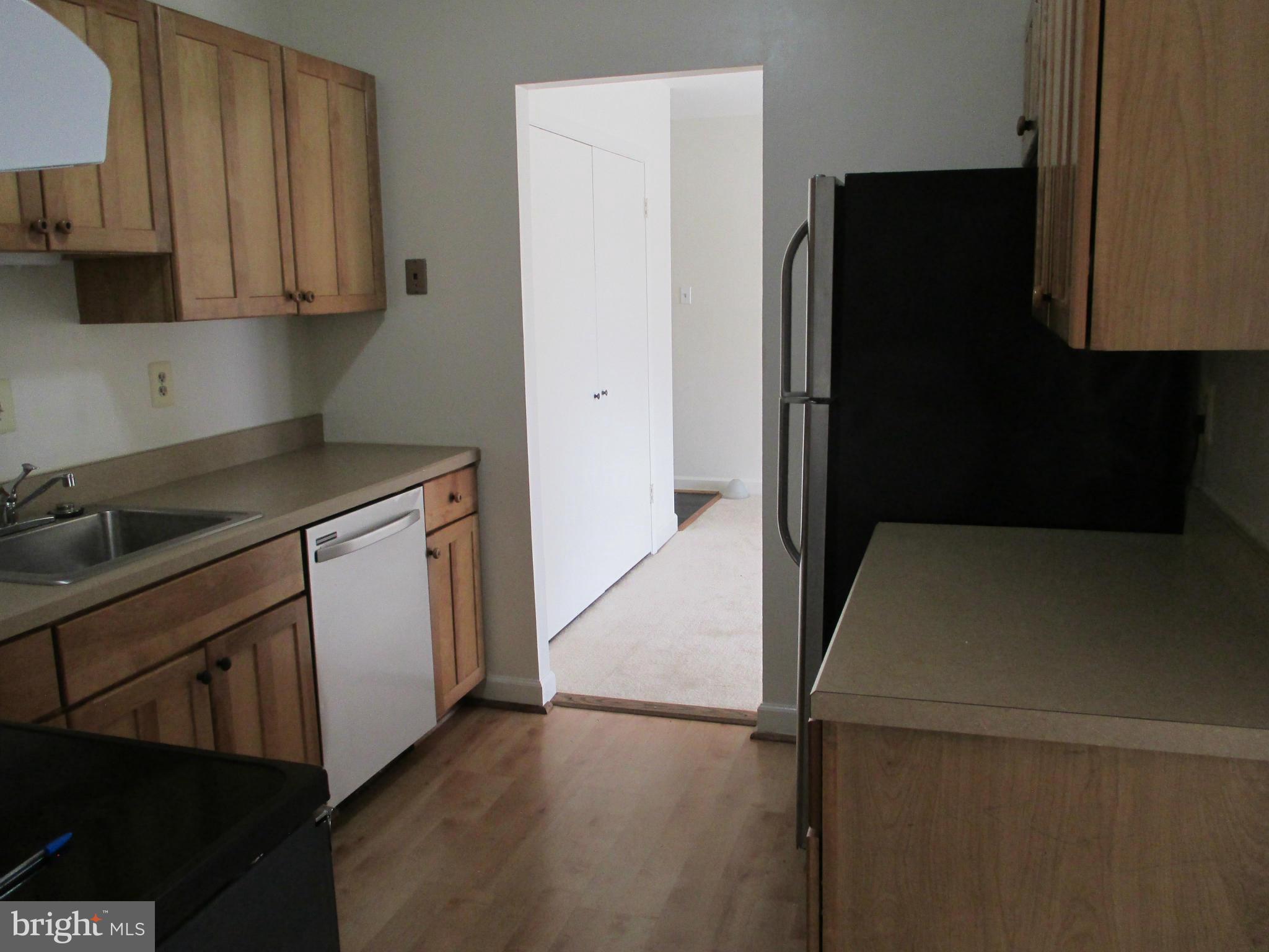 6260 Edsall Road, Unit 403 Alexandria, VA 22312 - Photo 8 of 15 a kitchen with a refrigerator and cabinets
