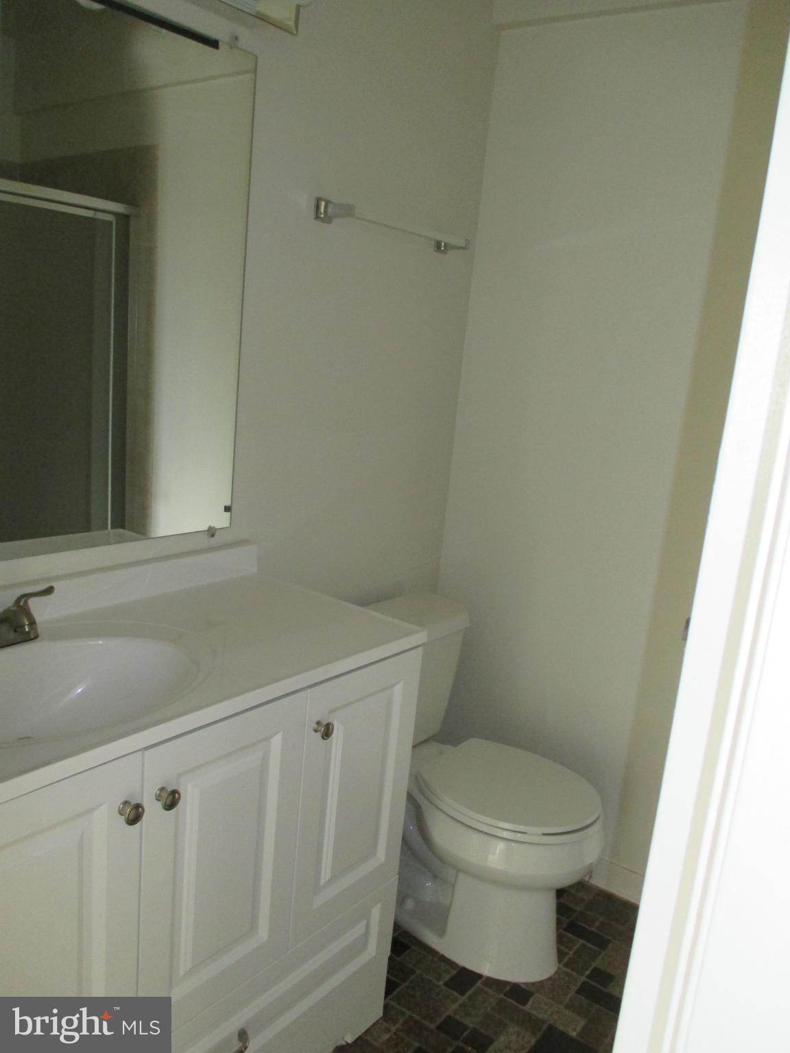 6260 Edsall Road, Unit 403 Alexandria, VA 22312 - Photo 9 of 15 a bathroom with a toilet a sink and a window