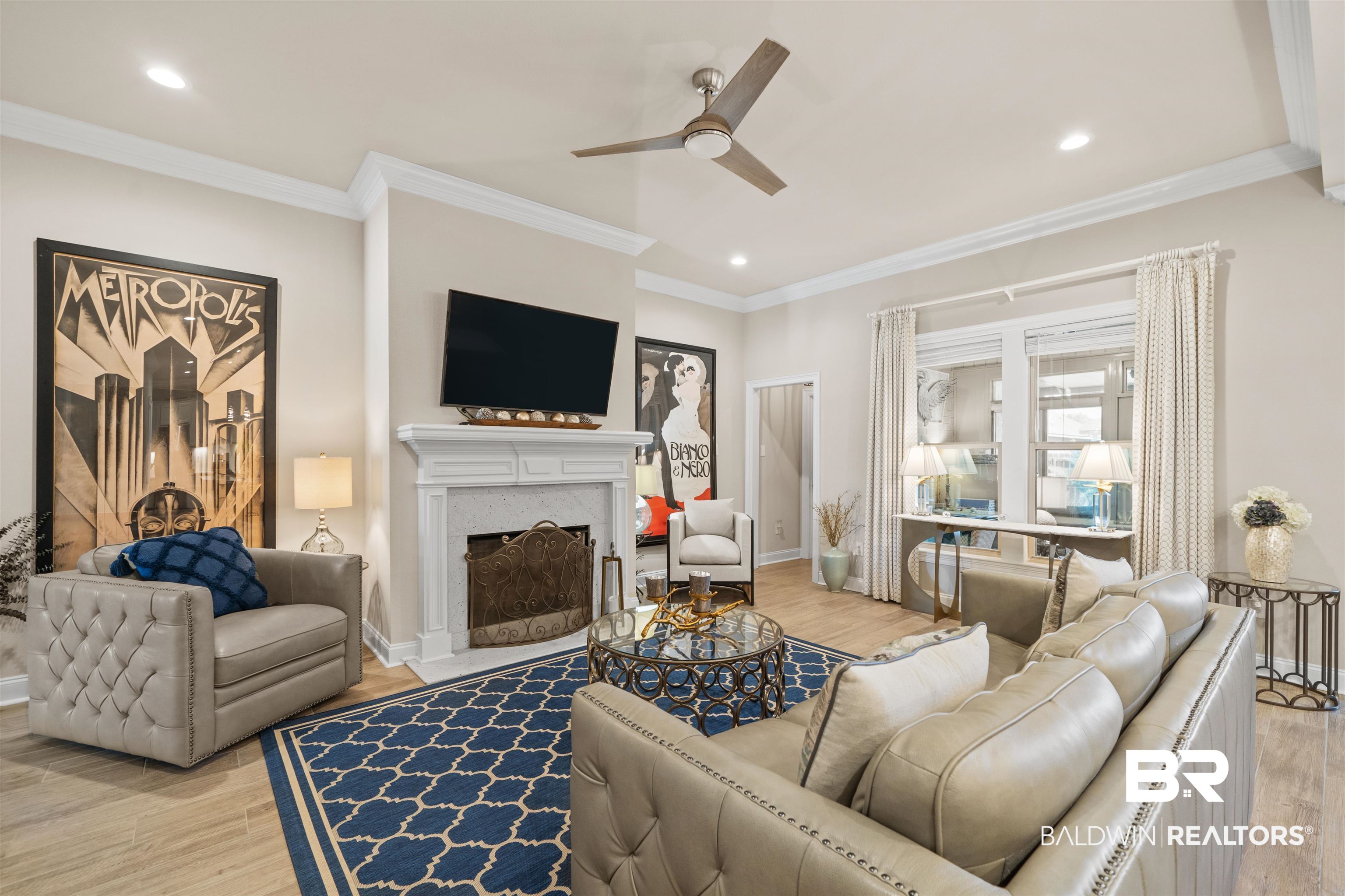 1509 Fenton Circle Foley, AL 36535 - Photo 10 of 34 Living room featuring a fireplace with flush hearth, crown molding, wood finished floors, and a ceiling fan