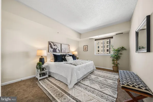 a bedroom with a bed and a potted plant