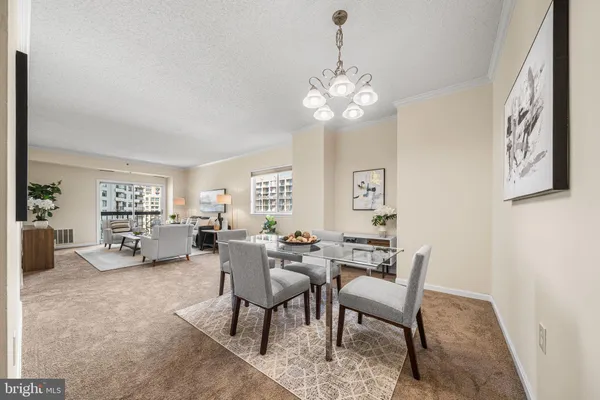 a view of a dining room with furniture and chandelier
