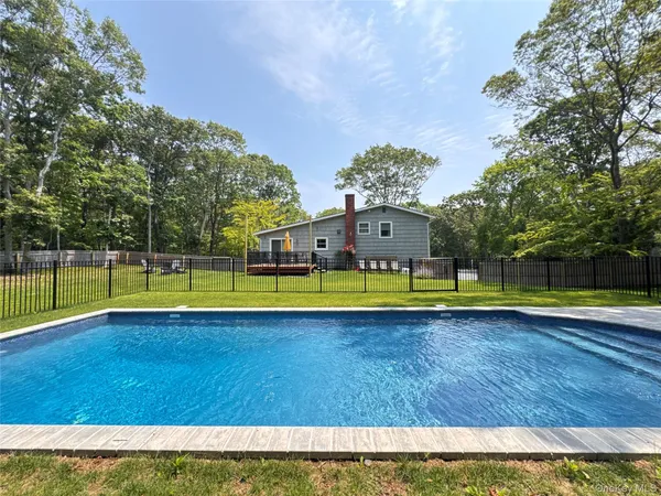 a view of a swimming pool with an outdoor space and seating area