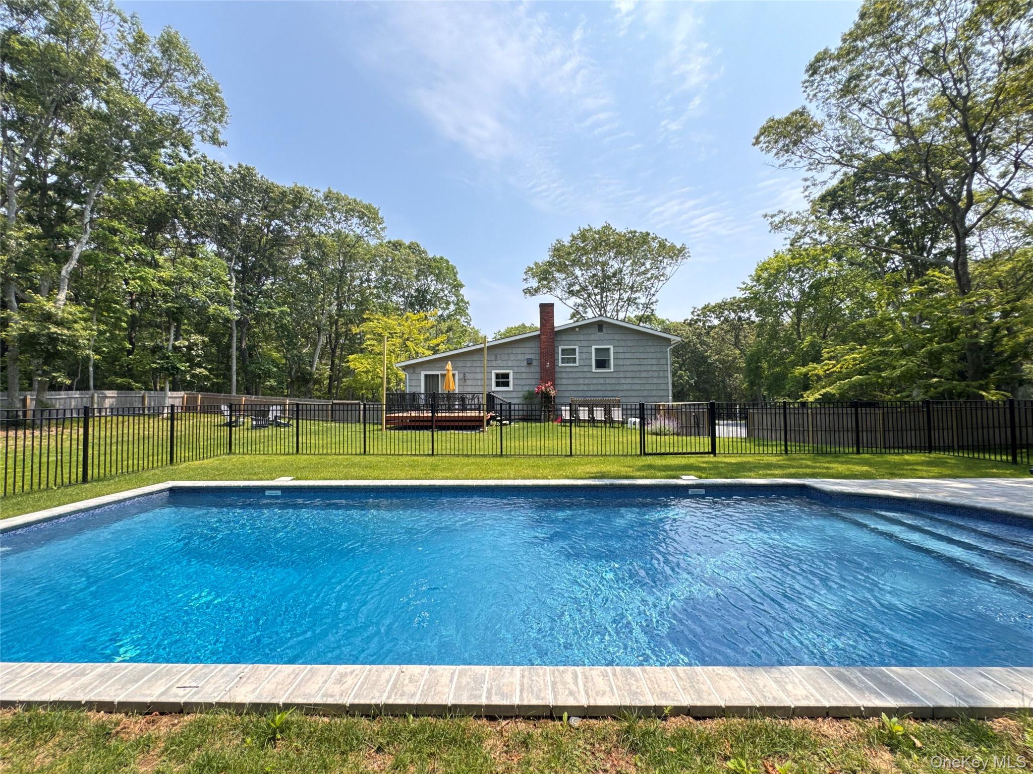 3 Debbie Trail Hampton Bays, NY 11946 - Photo 1 of 29 View of pool featuring a wooden deck