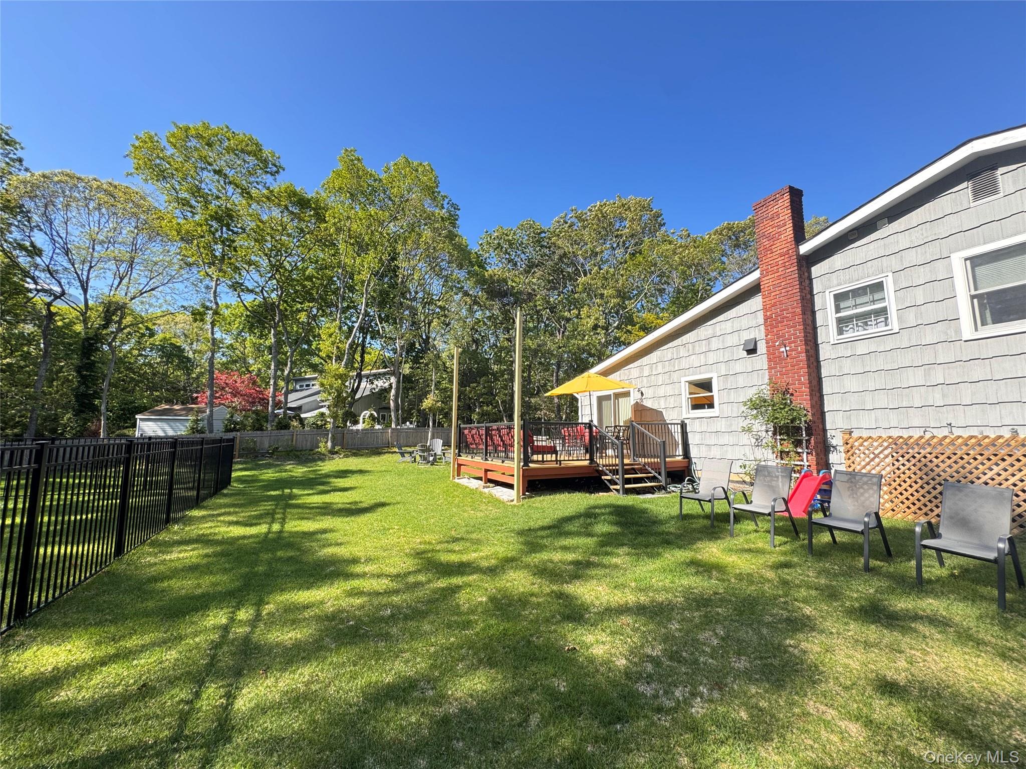 3 Debbie Trail Hampton Bays, NY 11946 - Photo 11 of 29 View of yard with a wooden deck
