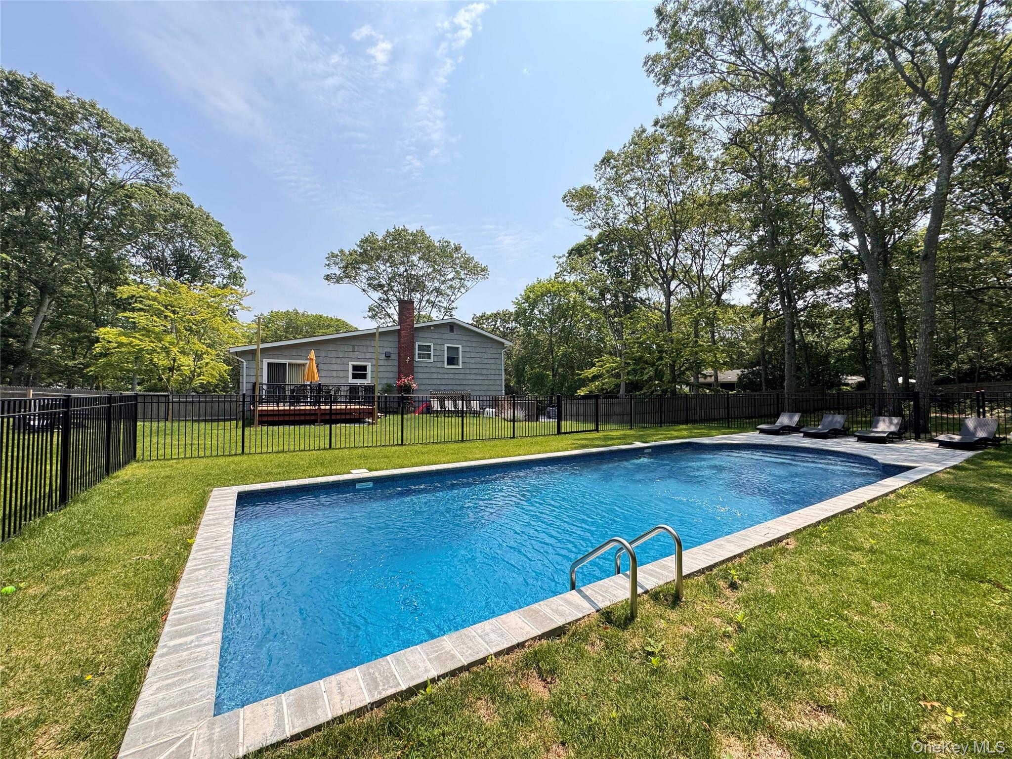 3 Debbie Trail Hampton Bays, NY 11946 - Photo 2 of 29 View of pool with a fenced backyard