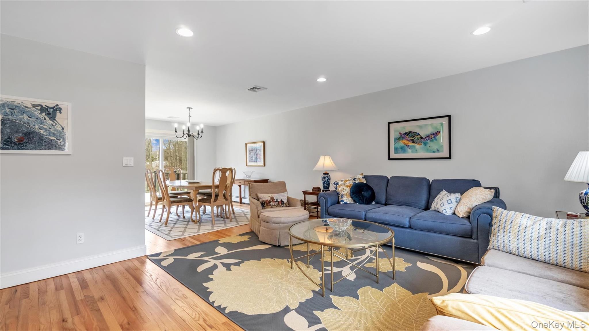 3 Debbie Trail Hampton Bays, NY 11946 - Photo 21 of 29 Living area featuring recessed lighting, visible vents, baseboards, a chandelier, and light wood-style flooring