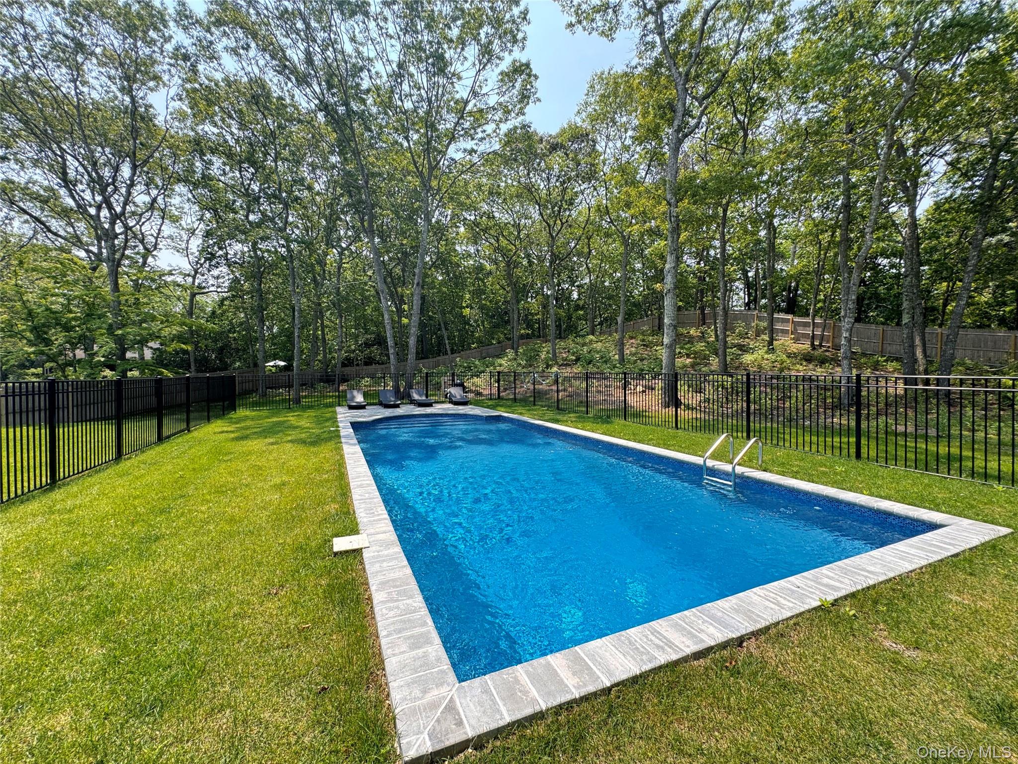 3 Debbie Trail Hampton Bays, NY 11946 - Photo 3 of 29 View of swimming pool with a fenced backyard
