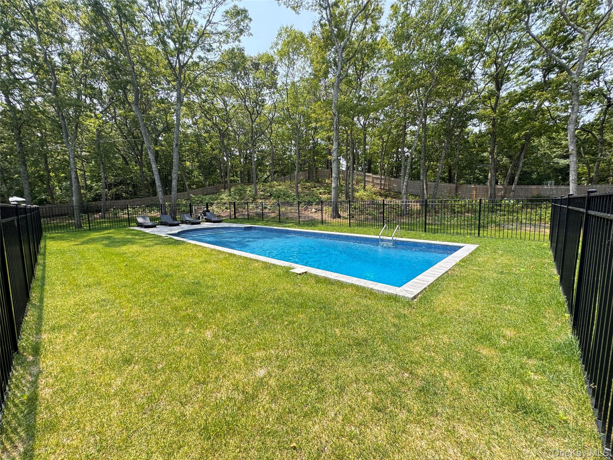 3 Debbie Trail Hampton Bays, NY 11946 - Photo 4 of 29 View of pool featuring a fenced backyard