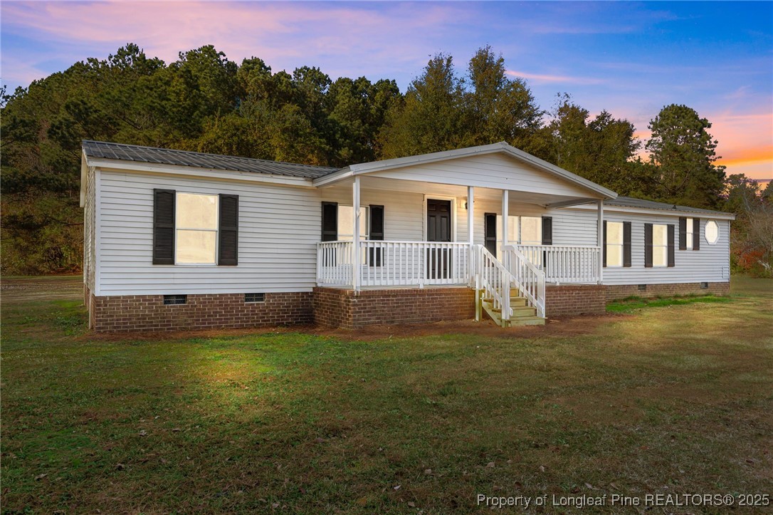5888 Butler Nursery Road Fayetteville, NC 28306 - Photo 1 of 42 a front view of a house with a garden