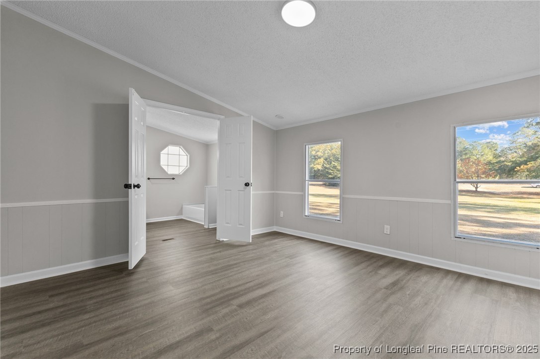5888 Butler Nursery Road Fayetteville, NC 28306 - Photo 14 of 42 an empty room with wooden floor and windows