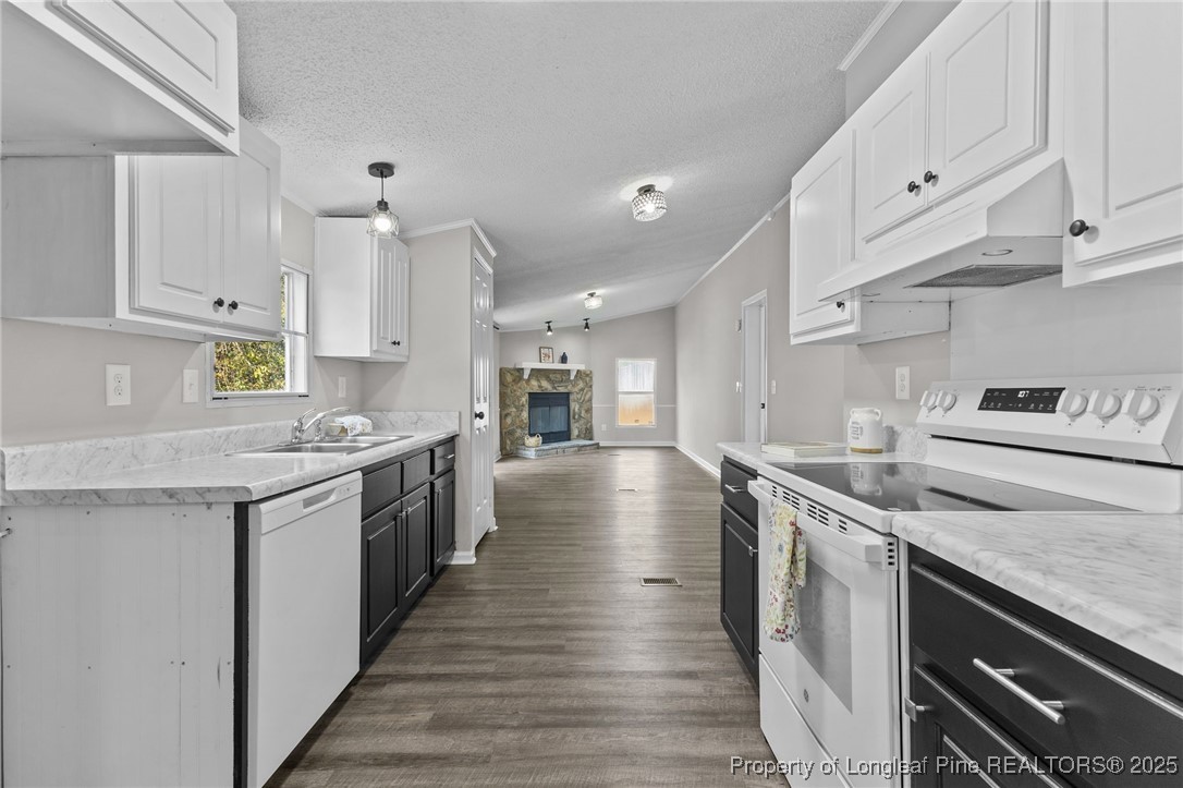 5888 Butler Nursery Road Fayetteville, NC 28306 - Photo 18 of 42 a kitchen with a stove and a white wooden cabinets