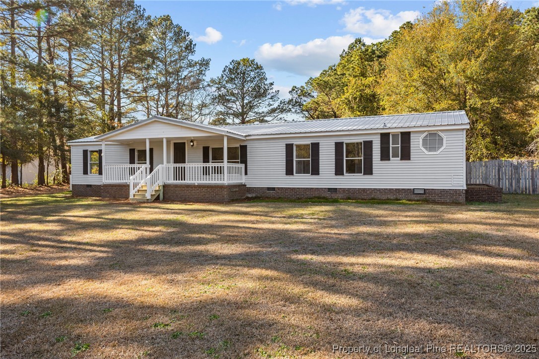 5888 Butler Nursery Road Fayetteville, NC 28306 - Photo 2 of 42 a front view of a house with a yard