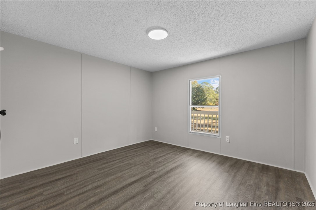 5888 Butler Nursery Road Fayetteville, NC 28306 - Photo 28 of 42 a view of an empty room with a window and wooden floor