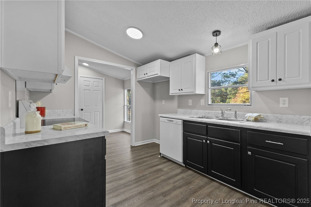 5888 Butler Nursery Road Fayetteville, NC 28306 - Photo 4 of 42 a kitchen with granite countertop a sink cabinets and wooden floor