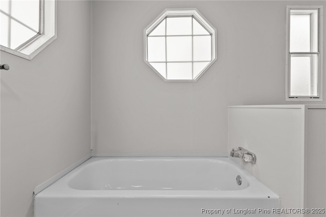 5888 Butler Nursery Road Fayetteville, NC 28306 - Photo 9 of 42 a white bath tub sitting next to a window