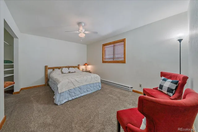 a bedroom with a bed and a view mirror