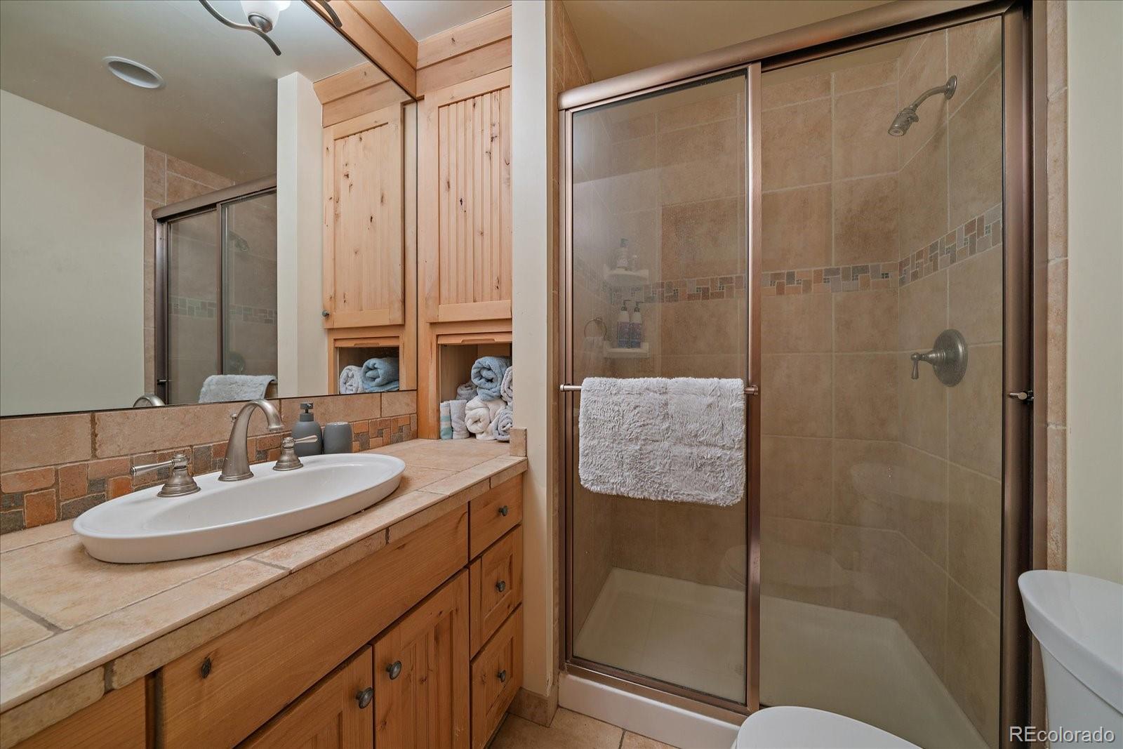 34 Normandy Road Evergreen, CO 80439 - Photo 18 of 45 a bathroom with a sink and mirror
