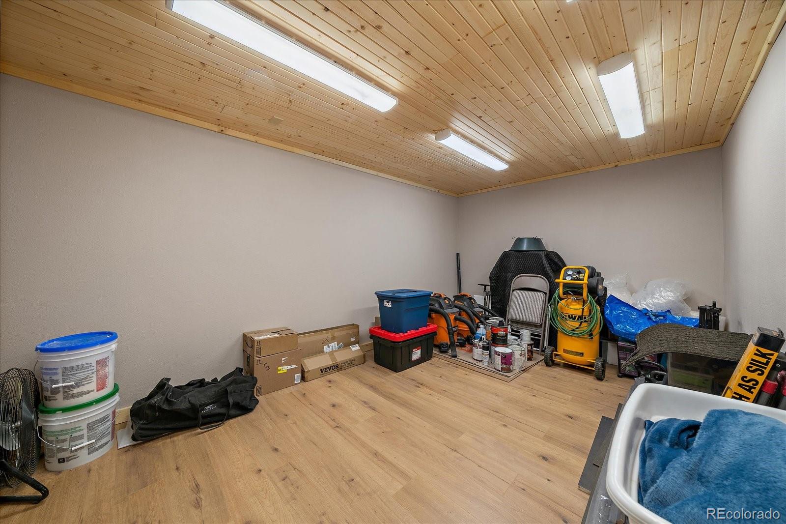 34 Normandy Road Evergreen, CO 80439 - Photo 30 of 45 a bedroom with bed and a chandelier