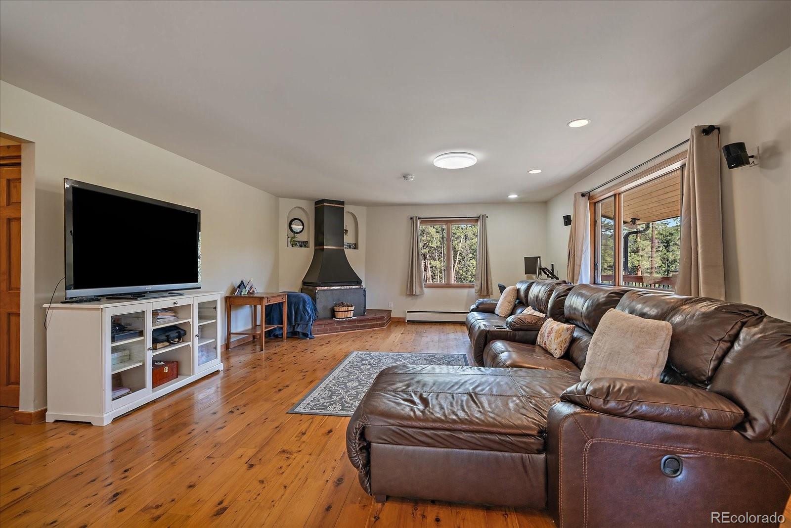 34 Normandy Road Evergreen, CO 80439 - Photo 6 of 45 a living room with furniture and a flat screen tv