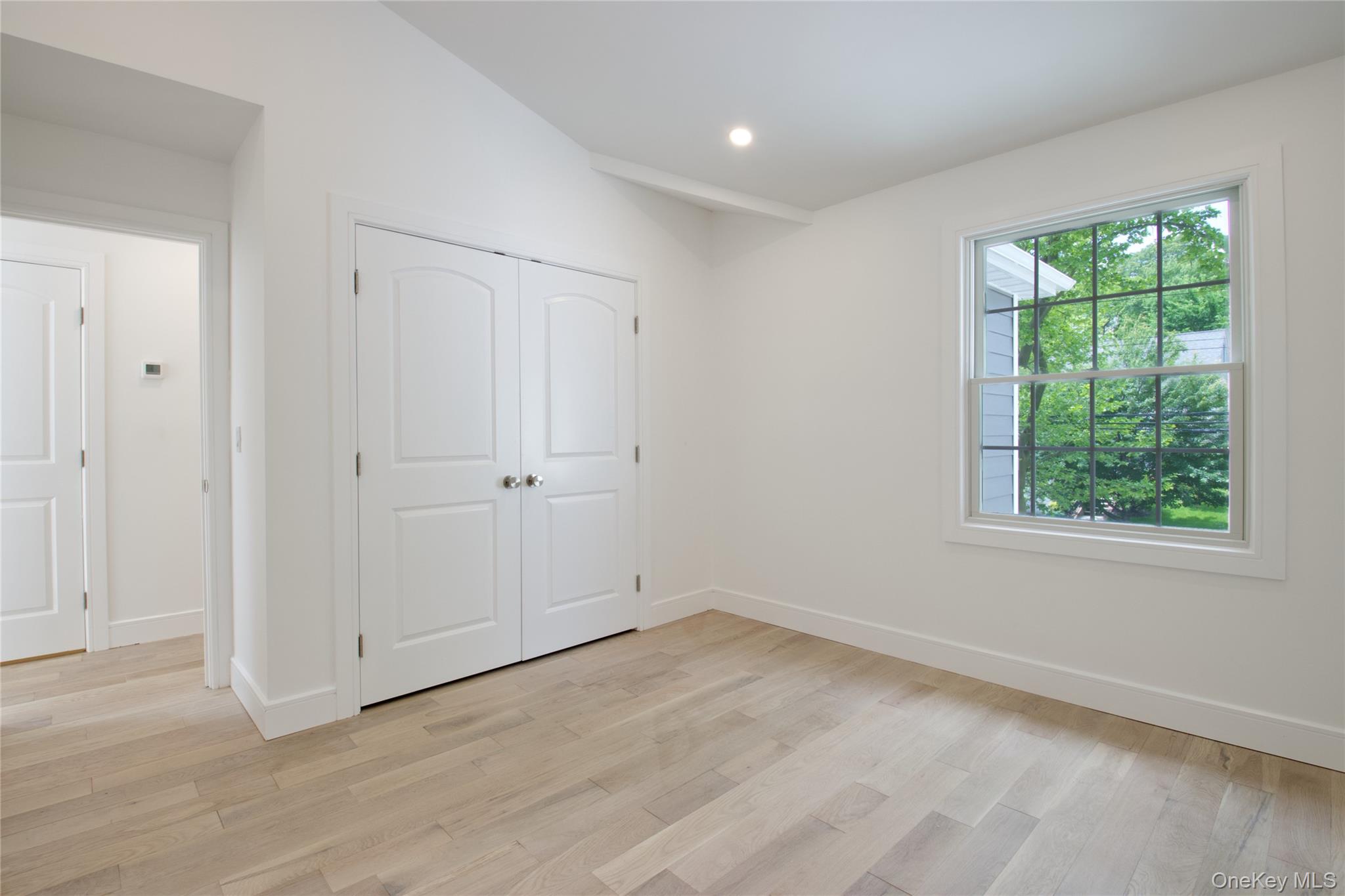 30 Kirkwood Road, Unit B Port Washington, NY 11050 - Photo 25 of 36 an empty room with wooden floor and window