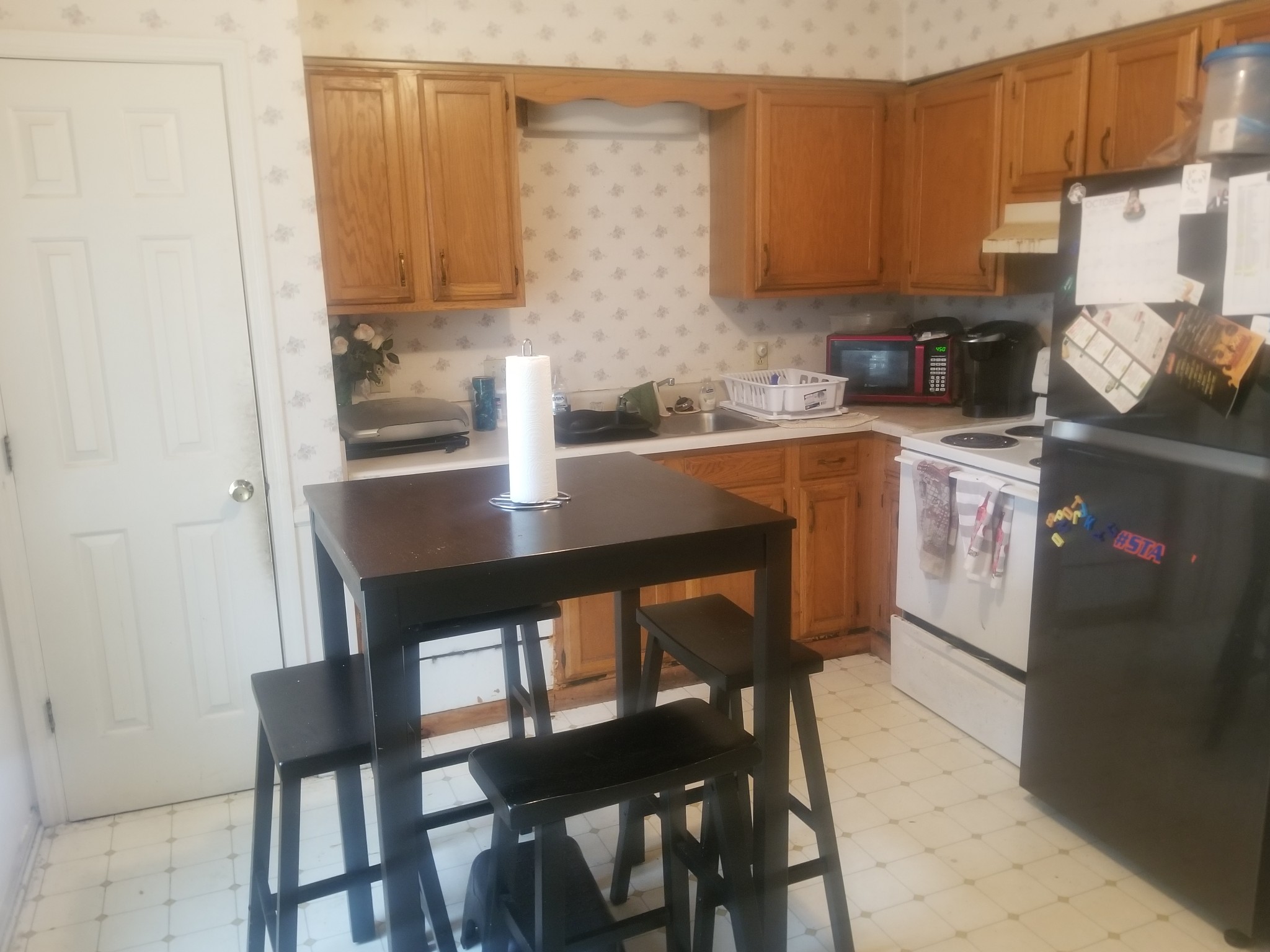 3239 Anderson Road Antioch, TN 37013 - Photo 3 of 9 a kitchen with a dining table chairs and a refrigerator