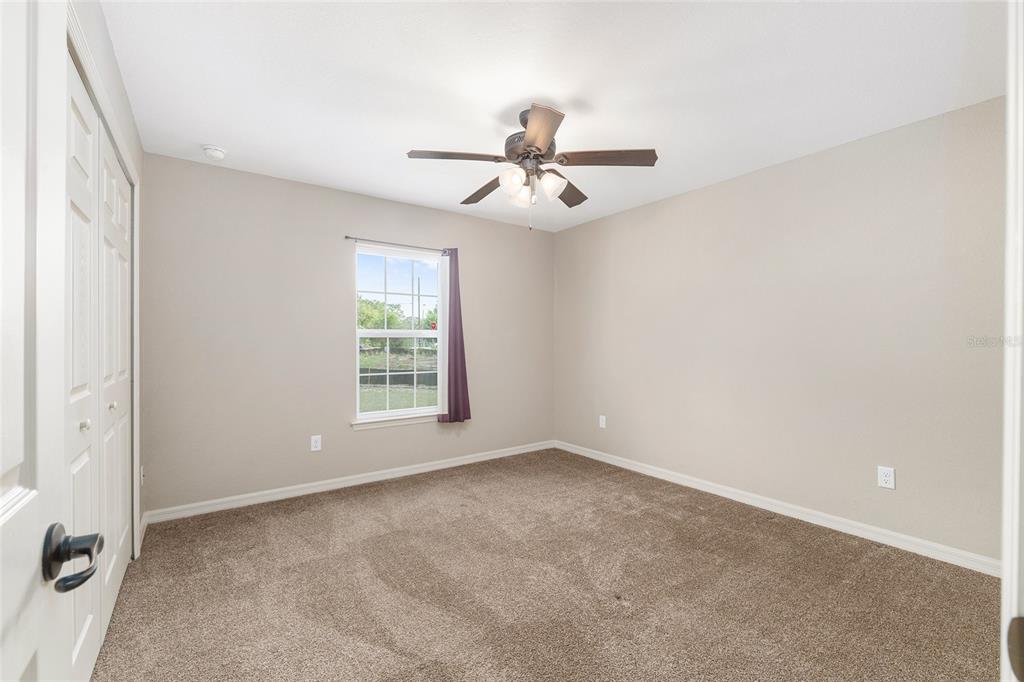 2 Hemlock Loop Drive Ocala, FL 34472 - Photo 25 of 28 an empty room with windows and fan