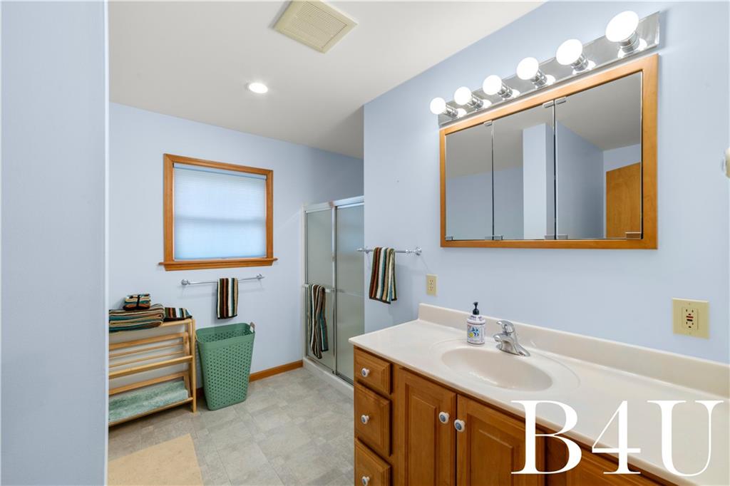 442 Fox Road Otego, NY 13825 - Photo 23 of 40 a en suite bathroom with a double vanity sink and a mirror