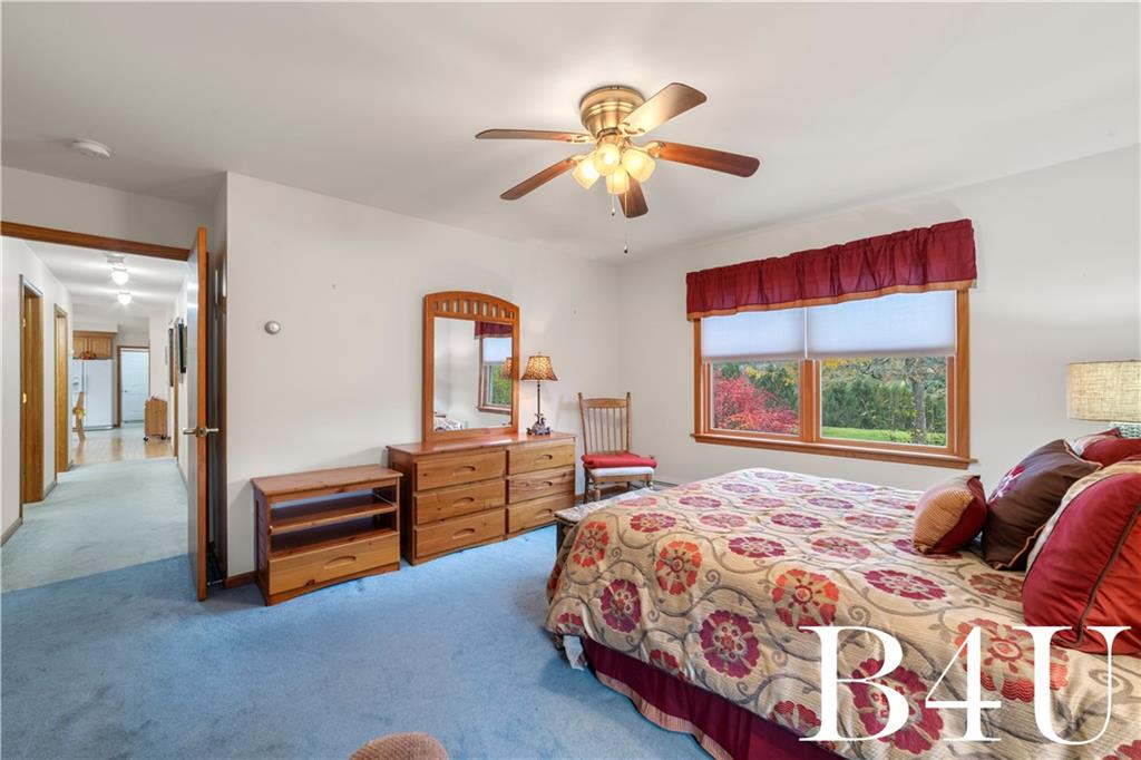 442 Fox Road Otego, NY 13825 - Photo 25 of 40 a bedroom with a bed and a chandelier