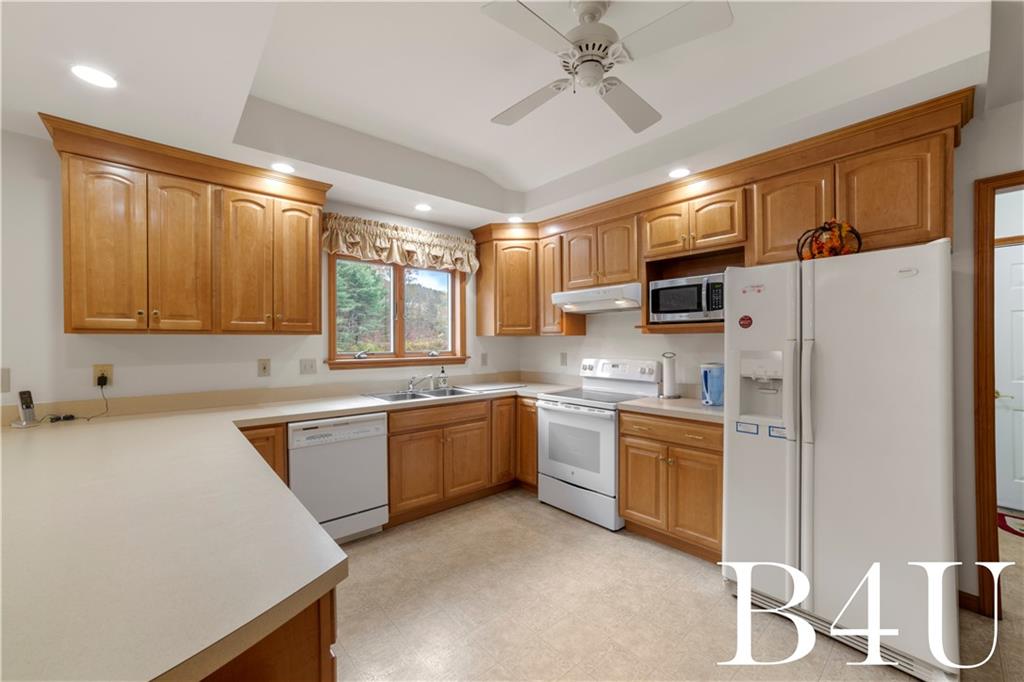 442 Fox Road Otego, NY 13825 - Photo 9 of 40 a kitchen with stainless steel appliances granite countertop a sink a stove a refrigerator a center island with wooden cabinets and floor