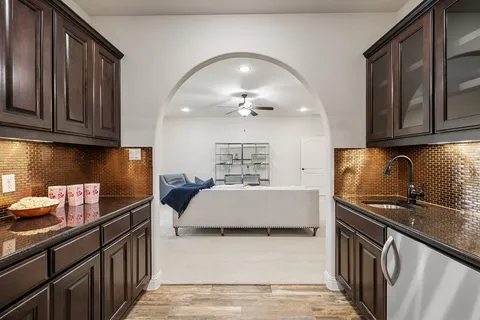 a kitchen with a sink stove and cabinets