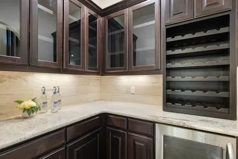 a kitchen with granite countertop cabinets and white appliances