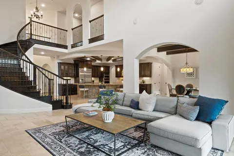 a living room with furniture and a chandelier
