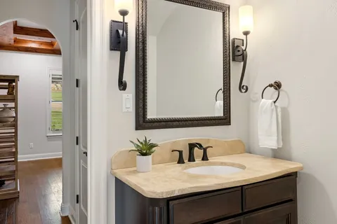 a bathroom with a sink vanity and a mirror