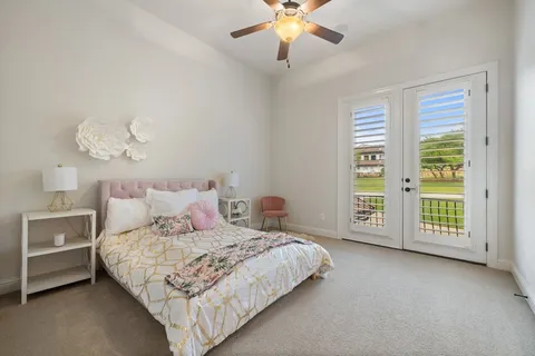 a bedroom with a large bed and a chandelier