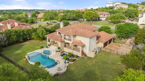 an aerial view of a house with garden space and street view