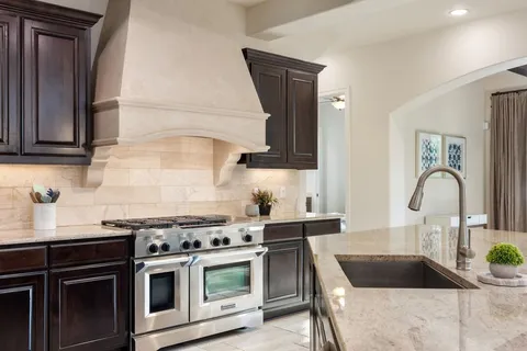 a kitchen with granite countertop a stove and a sink