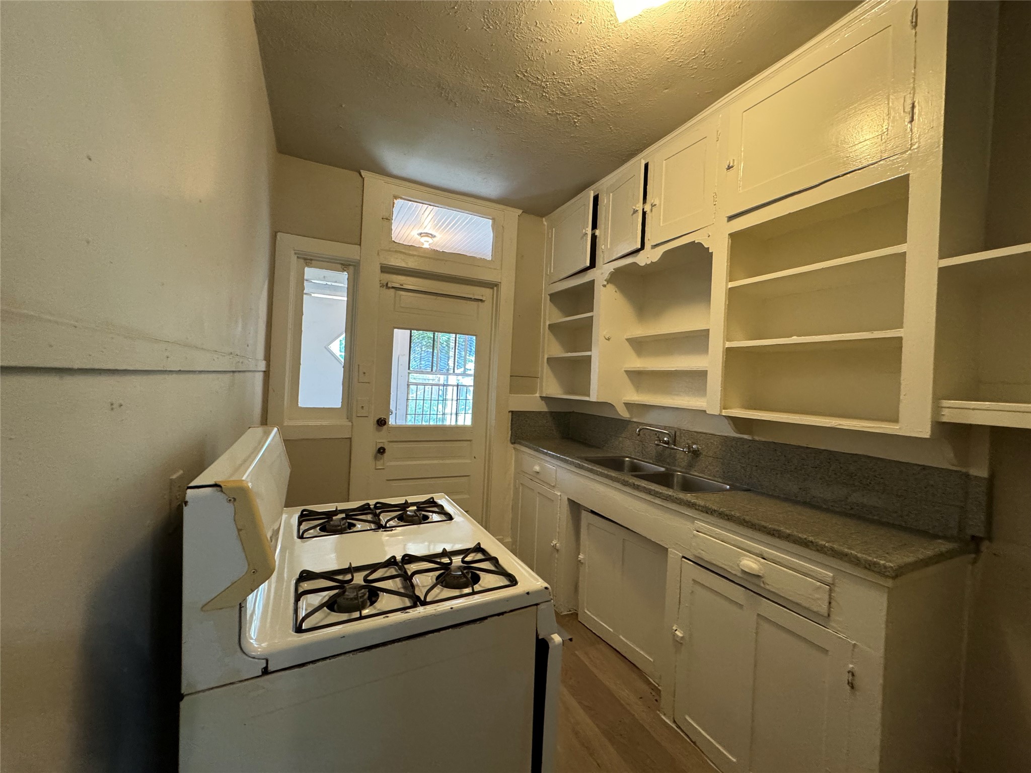 1711 West Main Street, Unit 2 Houston, TX 77098 - Photo 5 of 9 a kitchen that has a stove and a sink