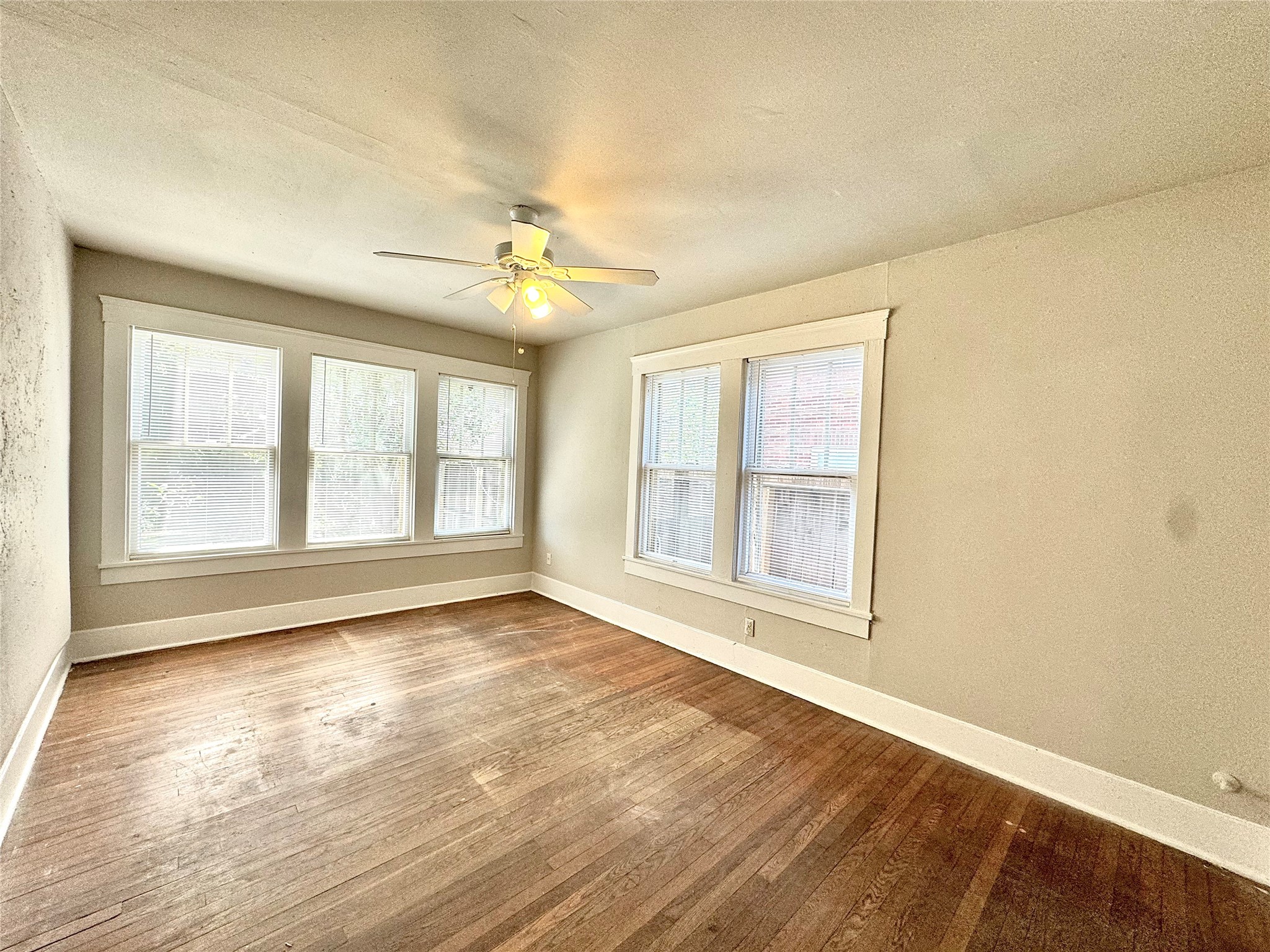 1711 West Main Street, Unit 2 Houston, TX 77098 - Photo 7 of 9 a view of an empty room with a window and wooden floor