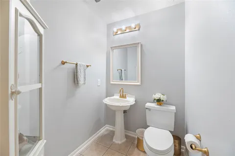 a white toilet sitting next to a bathroom sink