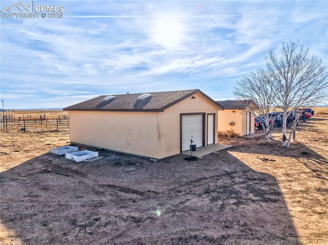 16830 Finch Road Colorado Springs, CO 80928 - Photo 38 of 49 Heated 2-car sized garage with a single-car door with a separate storage shed/chicken coop next to it.
