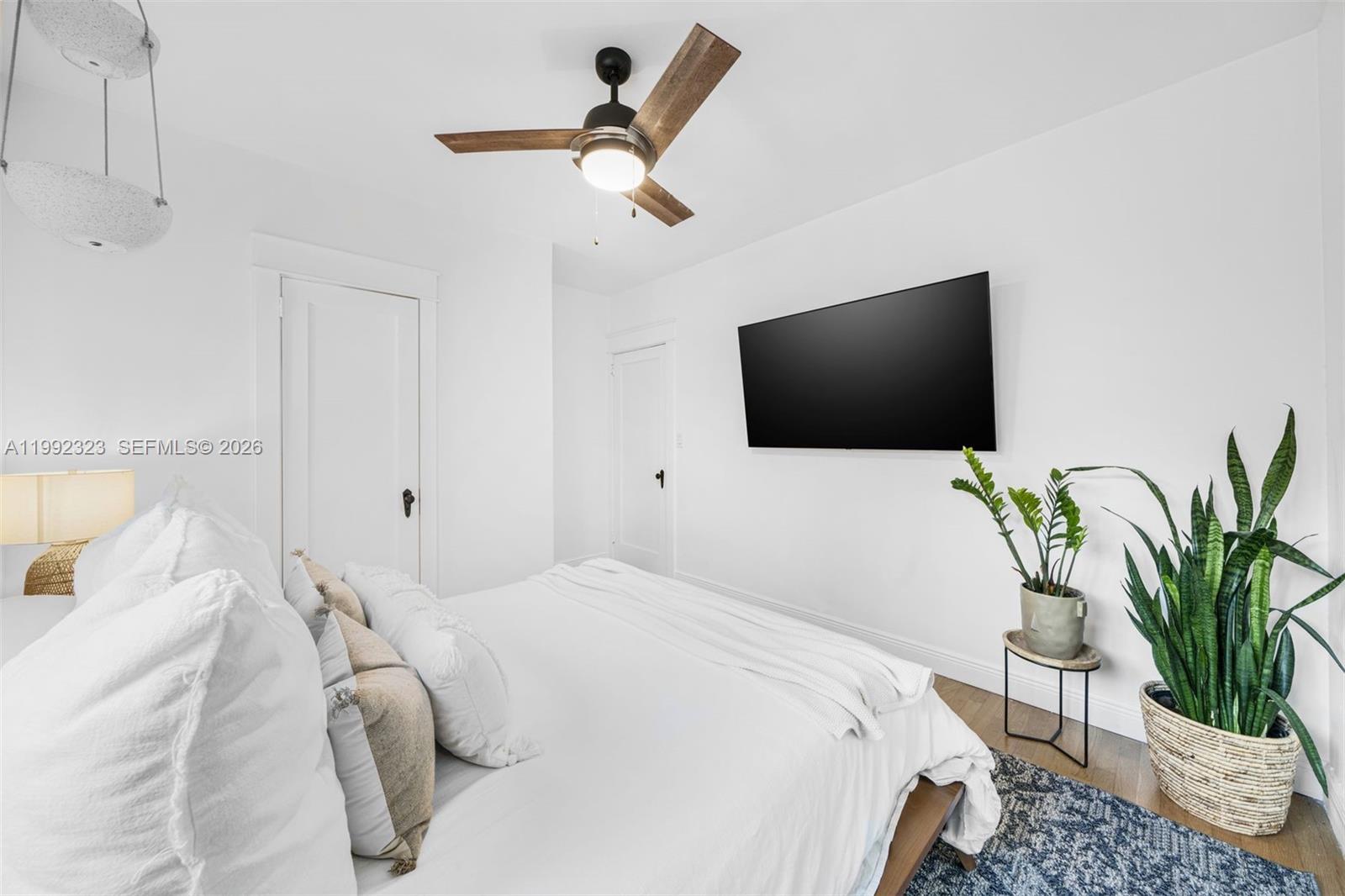 970 Northwest 10th Avenue Miami, FL 33136 - Photo 19 of 34 a bedroom with a bed and a flat screen tv